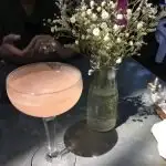Ice Plant Bar Pink Cocktail next to white flowers