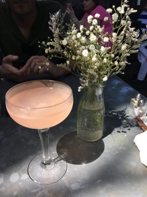 Ice Plant Bar Pink Cocktail next to white flowers