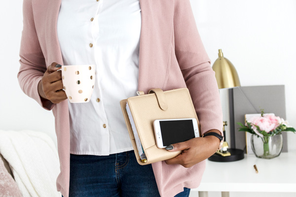 How to form LLC For bloggers with woman carrying mug of coffee, planner, and Iphone