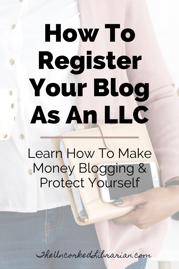 How To Register Blog As LLC Business Pinterest Pin with woman in pink sweater holding phone and planner