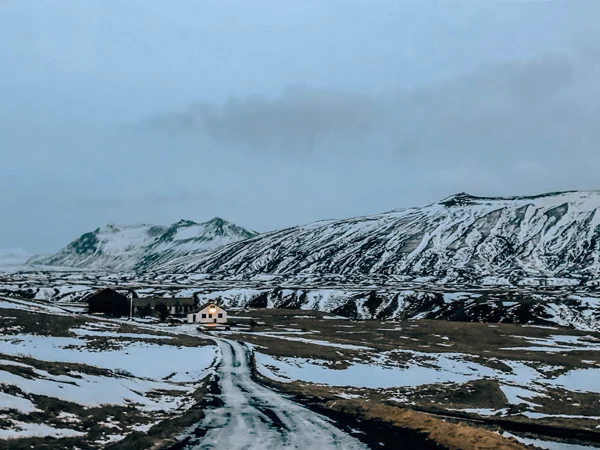 Icy Road Driving Conditions In Hella Iceland with house at the end