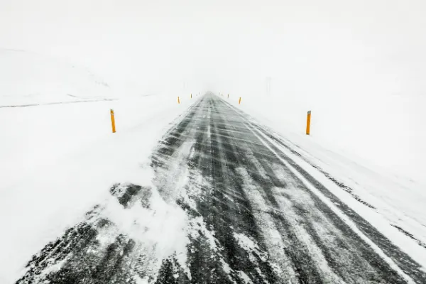 Strong wind driving in winter Iceland with road covered in blown snow