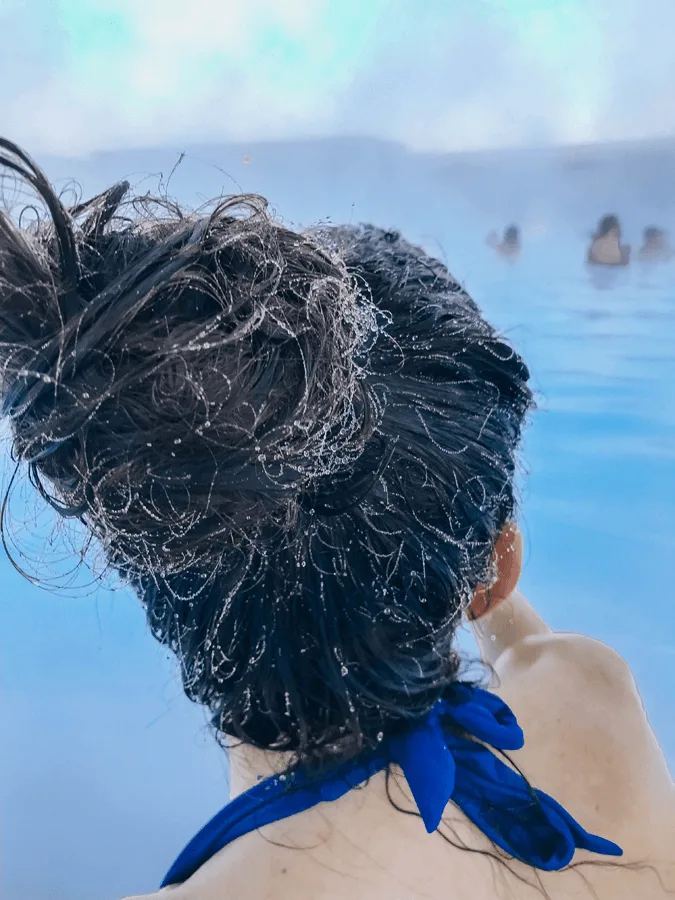 brunette woman in the Blue Lagoon Iceland with frozen hair