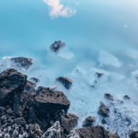 turquoise water with black rocks from The Blue Lagoon Geothermal Spa Iceland