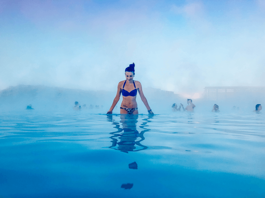 Brunette woman in a bikini in blue water at the Blue Lagoon Spa
