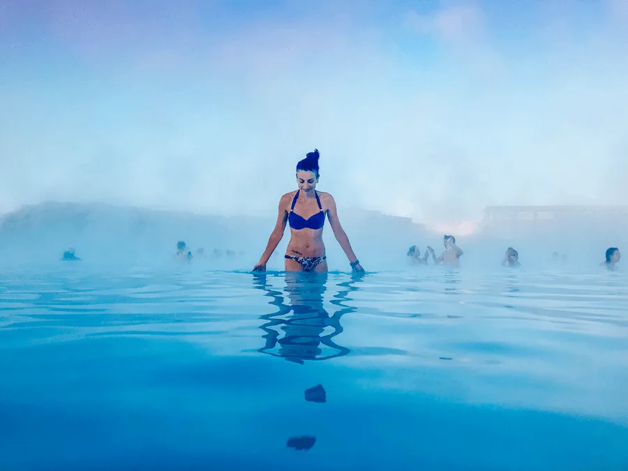 Brunette woman in a bikini in blue water at the Blue Lagoon Spa
