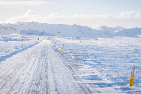 Yellow Poles Along Road While Driving In Iceland In Snow