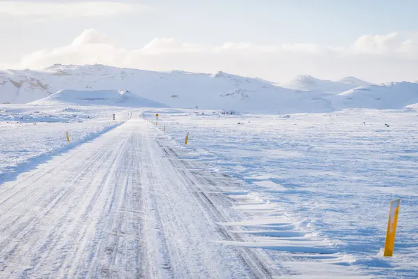 Yellow Poles Along Road While Driving In Iceland In Snow