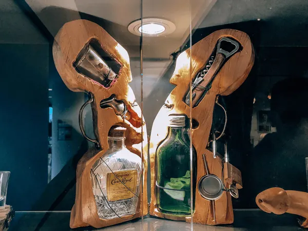 Icelandic Phallological Museum Exhibit with penis shaped container holding Icelandic spirits and openers