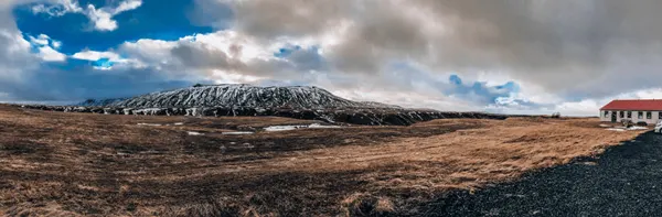 Hotel Selid Hella Southern Iceland Itinerary with mountains with white and red hotel