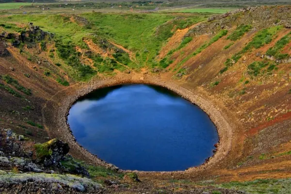 Kerid Crater Iceland with blue water in a hole surrounded by land