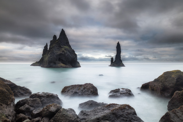 Reynisfjara Beach Black Sand Beach Basalt Columns with clouds and mist in Southern Iceland