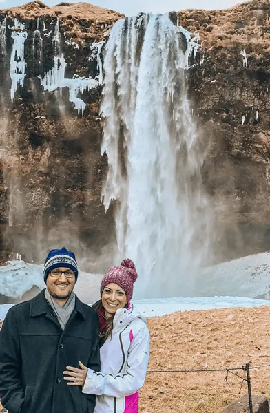 Seljalandsfoss Waterfall 7-Day Iceland Itinerary with white brunette female and woman in front of waterfall