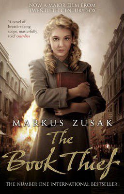 The Book Thief By Markus Zusak movie version book cover with blonde girl in gray brown coat holding book