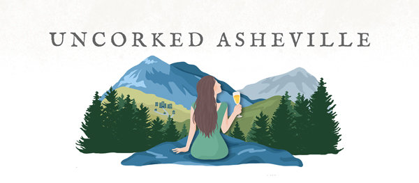 Uncorked Asheville Travel Blog Logo with brunette white woman holding white wine glass looking down on Blue Ridge Mountains and Asheville, NC