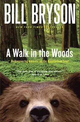 A Walk In The Woods By Bill Bryson book cover with green woods and brown bear face looking at the reader