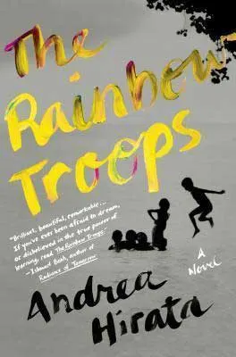The Rainbow Troops by Andrea Hirata book cover with yellow writing and shadows of children jumping in implied water