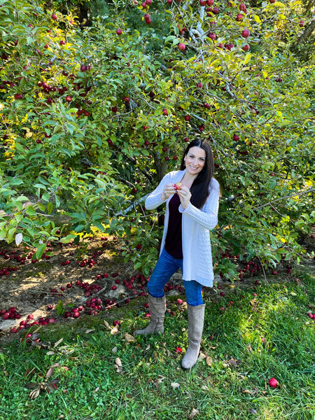 Christine picking apples at Coston Farm