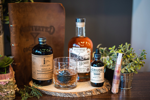 Smokey Old Fashioned Leather Bound Book with Old Fashioned, whiskey cube, Cultivated Cocktails whiskey, Crude salted and smoke bitters, and smoked sugar cubes