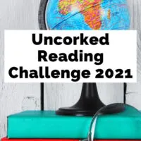 Uncorked Reading Challenge 2021 with globe on top of green and red books
