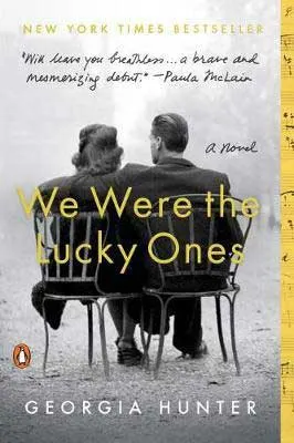 We Were The Lucky Ones by Georgia Hunter book cover with man and woman sitting on a bench