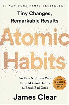 Atomic Habits by James Clear book cover with eggshell background color and golden lettering