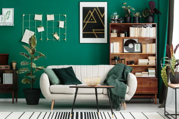 Book Blog Post Ideas Home Library Design with white couch, green walls, and bookshelf filled with books