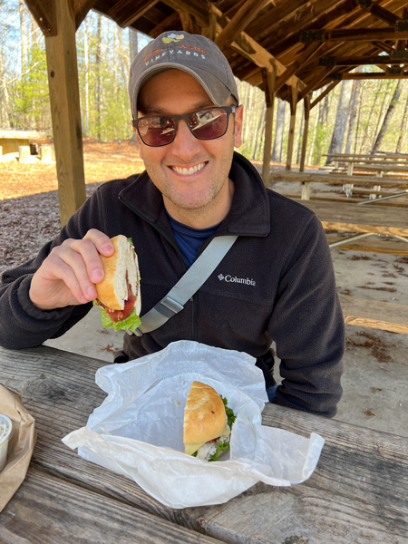 Tom eating a sandwich in picnic area