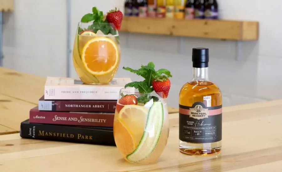 Mead Cocktails Recipes with two cocktails, bottle of Honeygirl Meadery Mead, and stack of Jane Austen books