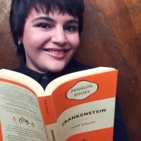 Sheree from Keeping Up With The Penguins, short black hair woman holding an orange stripped book, Frankenstein