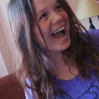 Writer Dagney McKinney white female with light brown hair wearing a purple shirt and smiling