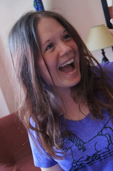Writer Dagney McKinney white female with light brown hair wearing a purple shirt and smiling
