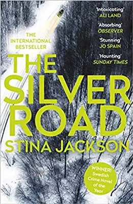 The Silver Road by Stina Jackson book cover with black and white forest