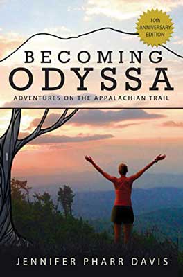 Becoming Odyssa: Adventures on the Appalachian Trail by Jennifer Pharr Davis book cover with woman with arms up toward mountains at sunrise or sunset and under a bare tree