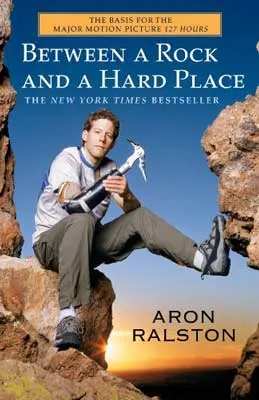 Between a Rock and a Hard Place by Aron Ralston book cover with white male and rock climbing gear sitting on a rock