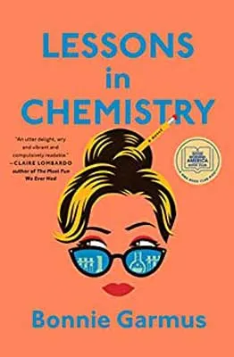 Lessons In Chemistry by Bonnie Garmus book cover with bright orange background and illustrated image of woman's face with just blonde hair with pencil in the bun, glasses with eyes, and red lips