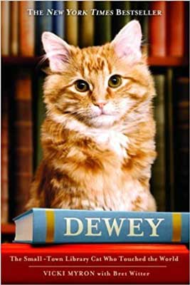 Dewey: The Small-Town Library Cat Who Touched the World by Vicki Myron book cover with orange and white cat along with stack of books