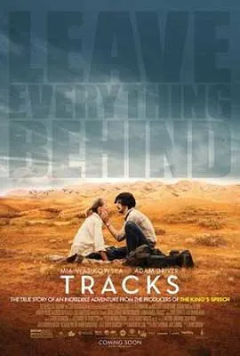 Tracks Film Poster with man and woman sitting on the brown sandy ground with man holding white woman's face