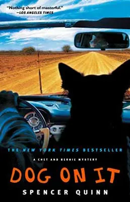 Dog on It by Spencer Quinn book cover with dog in car on dirt road sitting next to steering wheel
