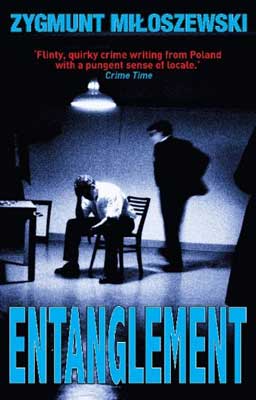 Entanglement by Zygmunt Miloszewski book cover with one man interrogating another in room under lamp 