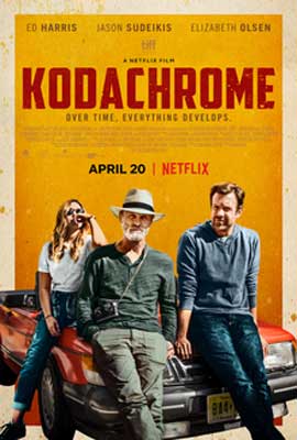 Kodachrome film poster with older white man wearing a hat and younger white man and woman sitting on car hood