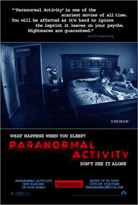 Paranormal Activity Movie poster with blue tinted image of man and woman huddled together in bed with door open