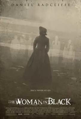 The Woman In Black Movie Poster with sepia gray tint over woman in dress standing in front of ghosts