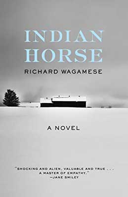 Indian Horse by Richard Wagamese book cover with building in the distance in the snow with one tree and gray sky