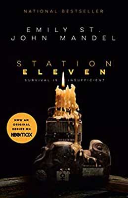 Station Eleven by Emily St. John Mandel book cover with lit candle and melting wax