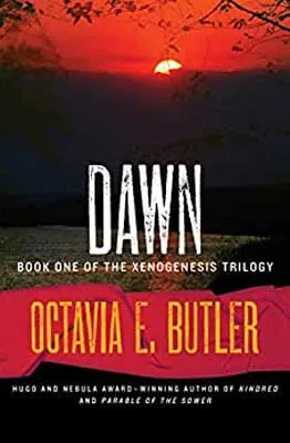 Dawn by Octavia E. Butler book cover with red yellow sun caught mid-mountain