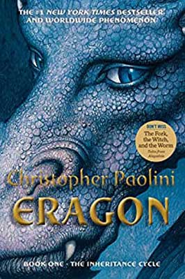 Eragon by Christopher Paolini book cover with blue hued and eyed dragon's face