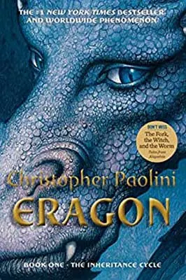 Eragon by Christopher Paolini book cover with blue hued and eyed dragon's face