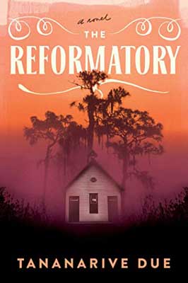 The Reformatory by Tananarive Due book cover with white building with trees and orange and pink hazy sky
