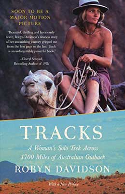 Tracks: A Woman’s Solo Trek Across 1700 Miles of Australian Outback by Robyn Davidson with woman in purple dress sitting on top of a camel